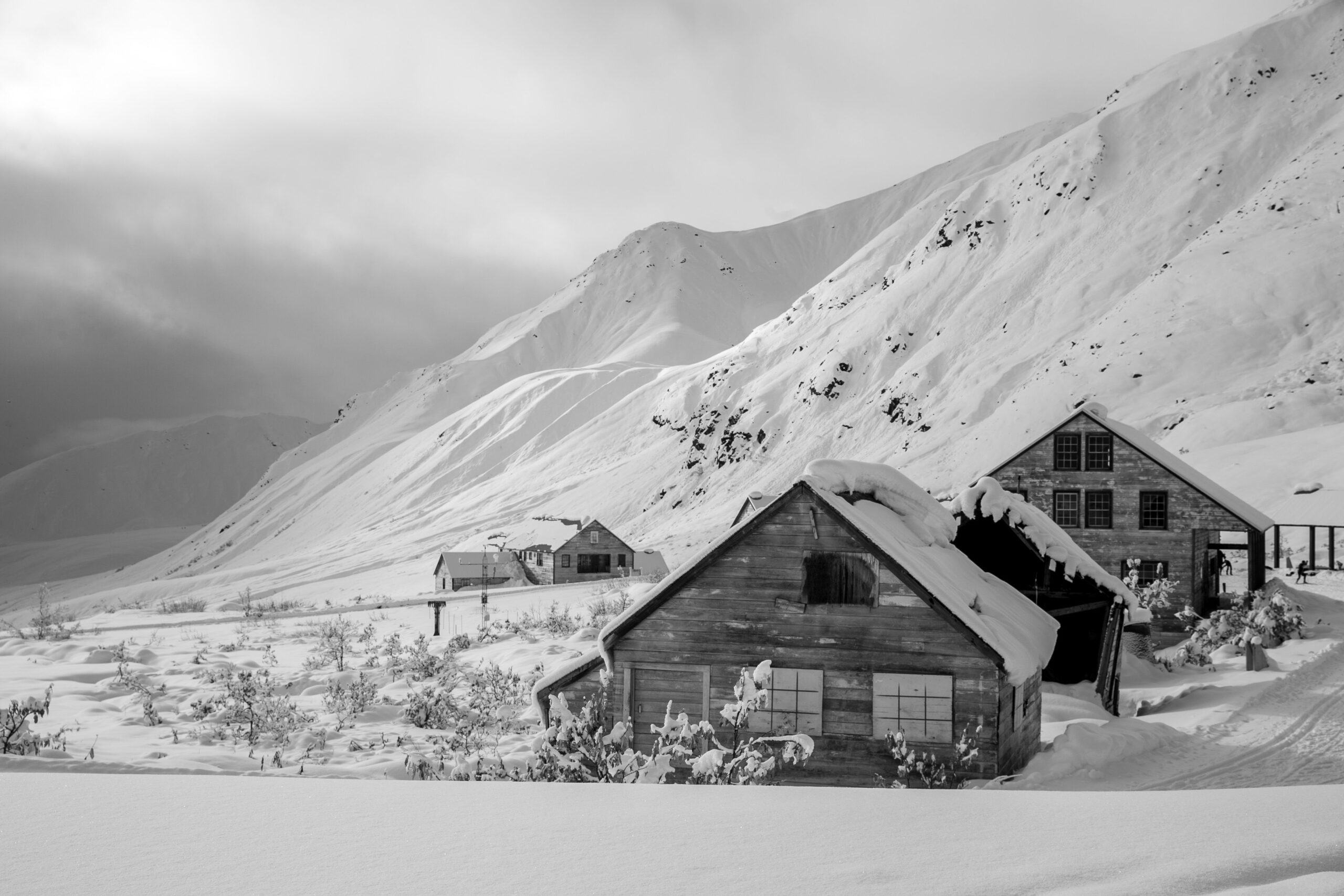 Grayscale Photo of House on Snow Covered Ground